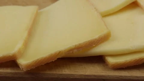 Slices of raclette cheese, close-up Stock Footage 257461498