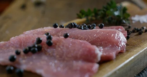 Slices of raw meat with pepper 4k Stock Footage 85835880