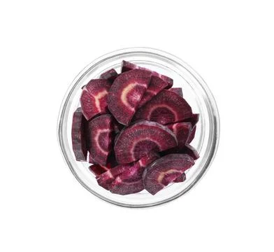 Slices of raw purple carrot in glass bowl isolated on white, top view Stock Photos