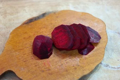 Slices of red beetroot. cutting beetroot. Woman cutting fresh red beet at t.. Stock Photos