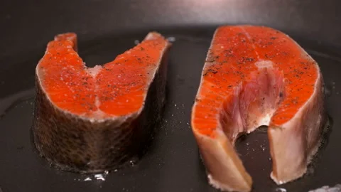 Slices of red fish fried in a pan Stock Footage 87808236