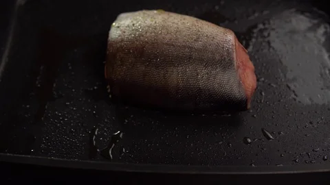 Slices of red fish fried in a pan Stock Footage 111074242
