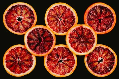 Slices of red oranges on a black background Stock Photos