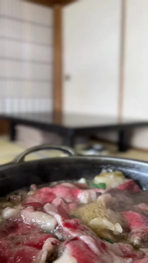 Slices of red raw wagyu beef cooking in steaming pot Stock Footage 328808072