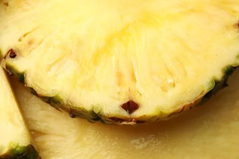 Slices of ripe pineapple as background, closeup Stock Photos