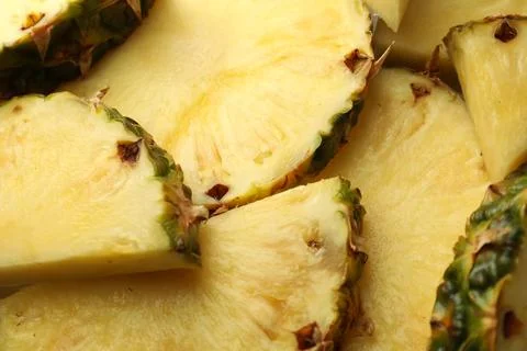 Slices of ripe pineapple as background, closeup Stock Photos