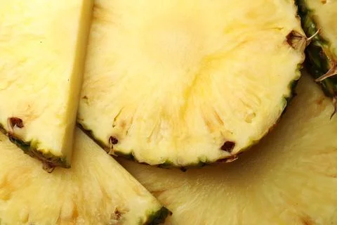 Slices of ripe pineapple as background, top view Stock Photos