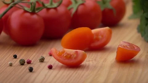 Slices of Ripe Tomato Falling on the Table. Stock Footage 73842794