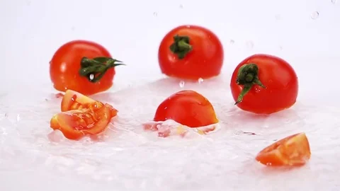 Slices of Ripe Tomato Falls on the Table. Video stock 72965773