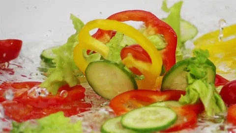 Slices of Ripe Vegetables are Falling on the Table. Stock Footage 73842307