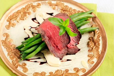 Slices of roast beef and string beans Stock Photos