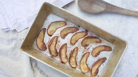 Slices of roasted apple arranged in tray Stock Footage 76100049