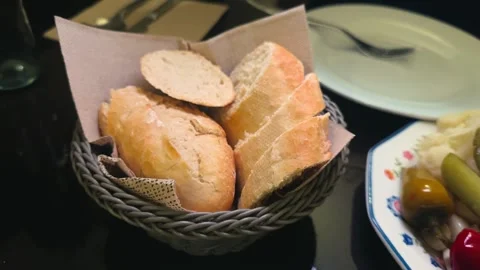 Slices of rustic bread on a in basket. Fresh bread served on a table in a Stock Footage 326903841