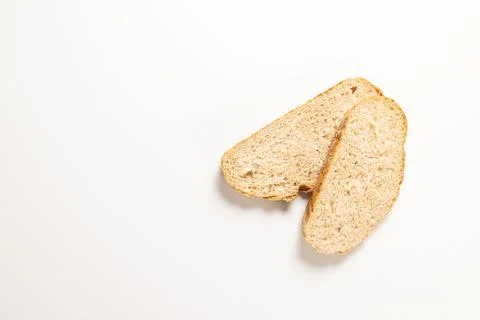 Slices of rustic sourdough bread on white surface 库存照片