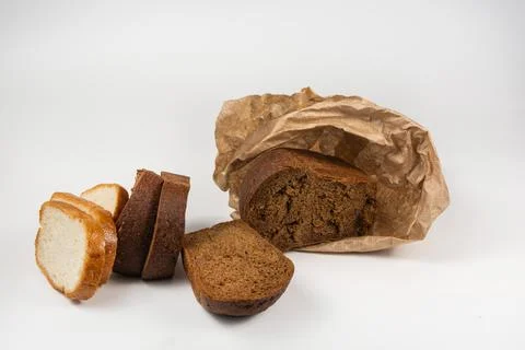 Slices of rye and wheat bread are laid out on a white background. Wrap half a Stock Photos