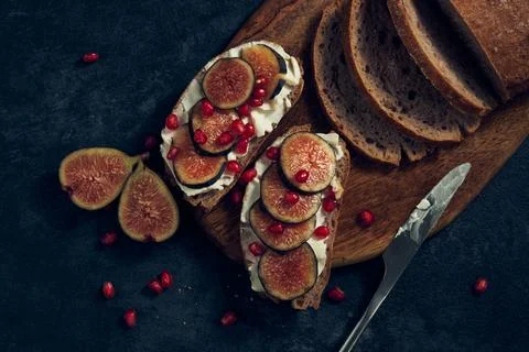 Slices of rye bread with figs and pomegranate Stock Photos