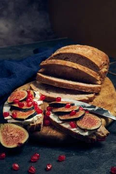 Slices of rye bread with figs and pomegranate Stock Photos