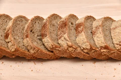 Slices of rye bread on kitchen plank Stock Photos