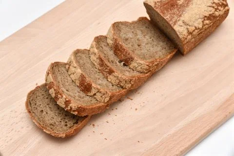 Slices of rye bread on kitchen plank Stock Photos