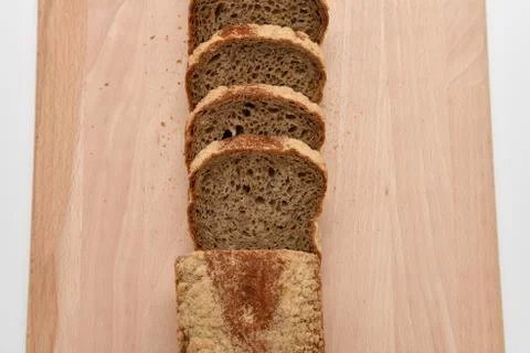 Slices of rye bread on kitchen plank Stock Photos