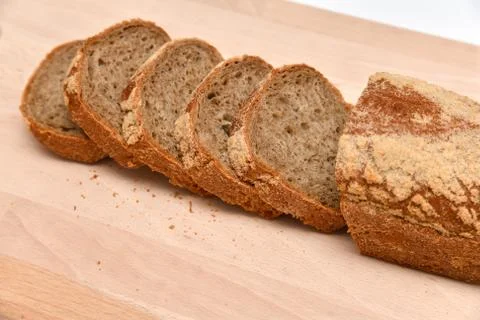Slices of rye bread on kitchen plank Stock Photos