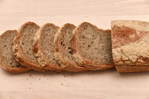 Slices of rye bread on kitchen plank Stock Photos