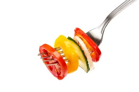 Slices of salad vegetables on a fork Stock Photos
