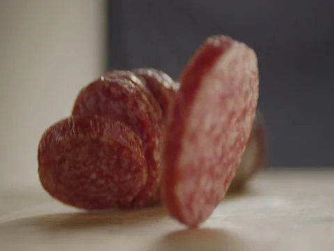 Slices Of Salami Roll On The Table Stock Footage 73035987