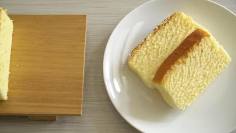 Slices of soft sponge cake with caramel on a white plate Stock Photos