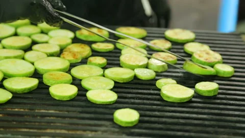 Slices of squash roasting on grill Video stock 96642542