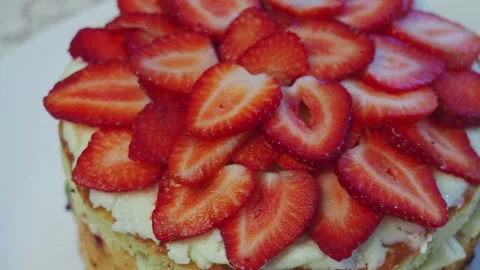 Slices of Strawberry on top cake Stock Footage 306552188