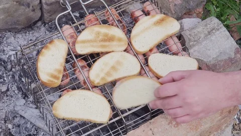 Slices of tasty bread are roasted on the fire Stock Footage 102036689