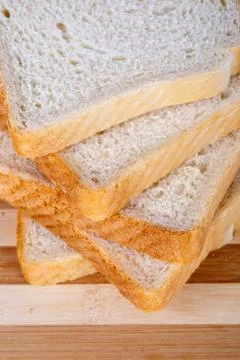 Slices of Toast Bread on Breadboard Stock Photos