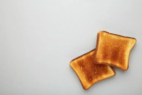 Slices of toast bread on grey background with copy space Stock Photos