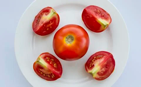 Slices of tomato on white background Stock Photos