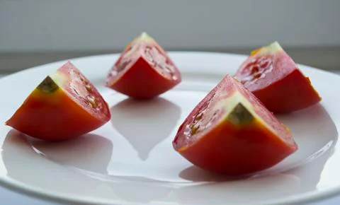 Slices of tomato on white background Foto stock