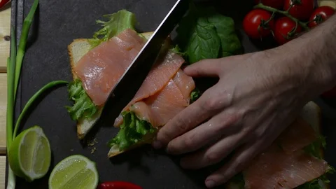 Slices two toasts with lettuce and fresh fish. Healthy breakfast Stock Footage 122490165