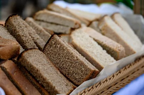 Slices of various types of bread arranged in a woven basket Stock Photos