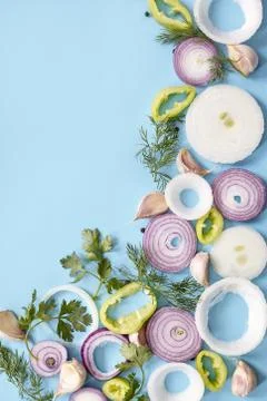 Slices of vegetables in a triangular pattern over a blue background 스톡 사진