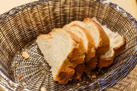 Slices of white bread in basket Stock Photos