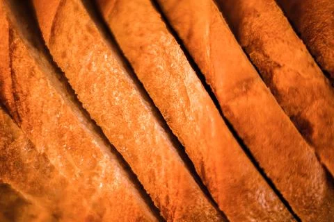 Slices of white bread close up as a background. backdrop of rough textured su Stock Photos
