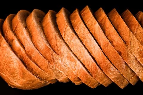 Slices of white bread close up isolated on a black background. rough textured Stock Photos