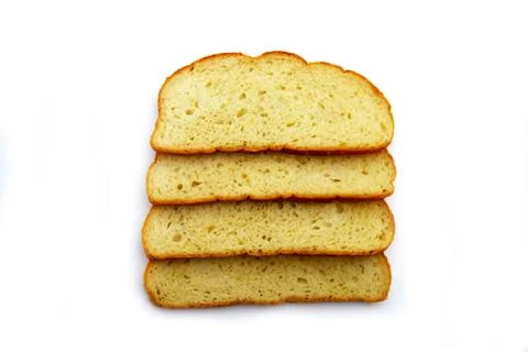 Slices of white bread on a white background. Stock Photos