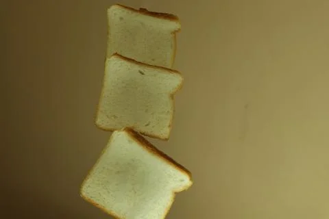 Slices of white wheat bread fly Stock Photos