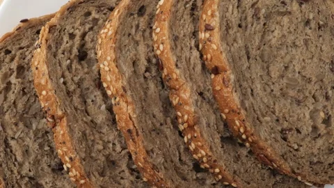 Slices of whole grain bread rotating Stock Footage 343433870