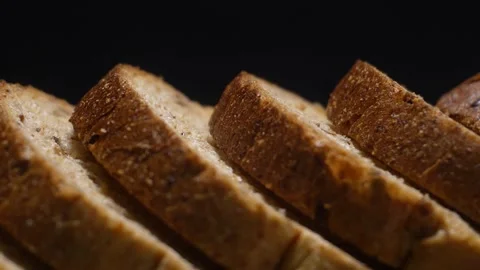 Slices of whole grain bread. Shooting parallax from the side. Close up. Stock Footage 310157063