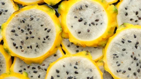 Slices of yellow dragon fruit texture background top view Stockbeeldmateriaal 337933115