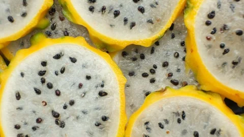 Slices of yellow dragon fruit texture background top view. Stock Footage 339614700