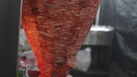 Slicing up al pastor as it gets cooked  Stock Footage 297242628