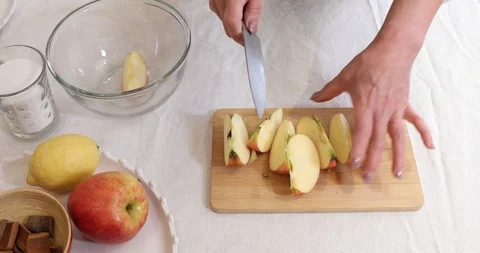 Slicing apple on chopping board to make preserves Stock Footage 105142221